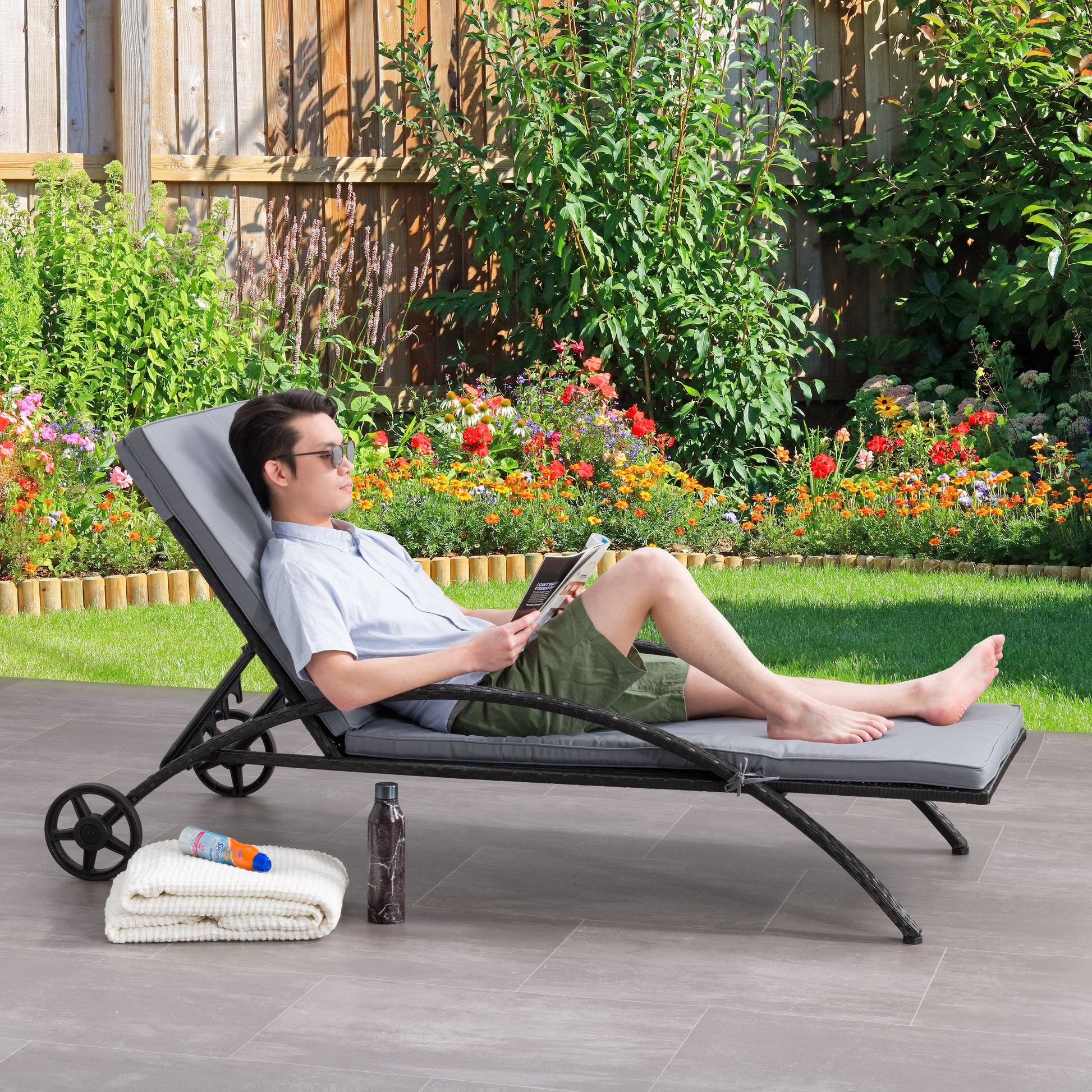 black and ash grey Outdoor Wicker Lounge Chair Parksville Collection lifestyle scene by CorLiving#color_black-and-ash-grey